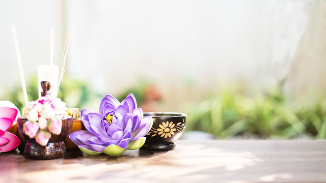 Spa still life with perfume bottle and lotus flower,Spa massage compress balls, herbal ball on the wooden with treaments spa , Thailand, select focus
