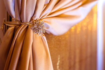 Crystla brooch holds pink silk curtain