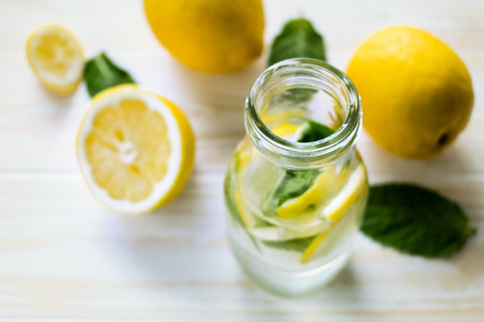 Lemonade and lemons with fresh mint on table