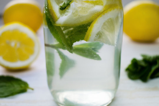 Homemade lemon juice in a bottle with mint