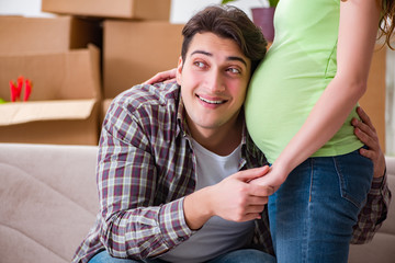 Fototapeta premium Young couple of man and pregnant wife expecting baby