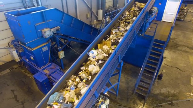 Waste sorting. Factory conveyor working at a recycling plant. 4K.