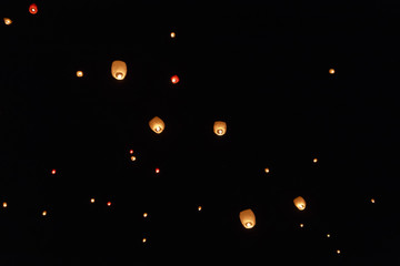 Sky lanterns flying above the beautiful city of Avila
