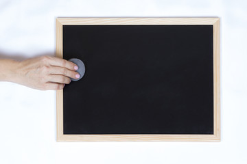 woman hands hand erasing a blackboard empty
