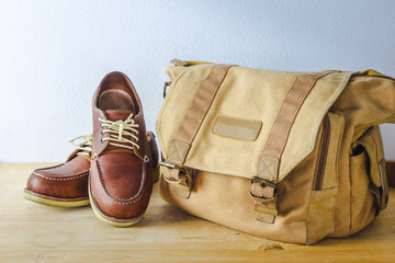 Fototapeta premium Men's accessories classic Bag and shoes on wooden table background.