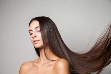 Young woman posing with her gorgeous long flying hair.