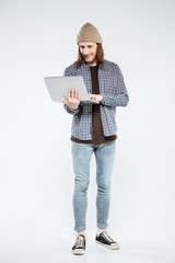 Vertical image of hipster using laptop