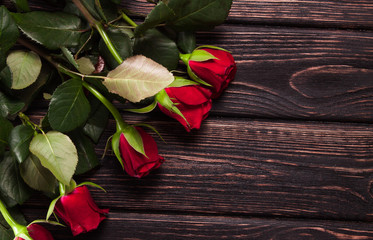 Fresh roses on wood desk with card