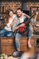 Fototapeta na wymiar Young couple with guitar