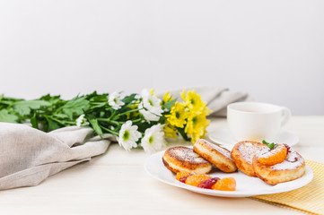 cheese pancake with citrus fruits and jam on a wooden table with tea. Breakfast concept