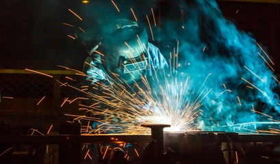 Worker,welding in a car factory with sparks, manufacturing, industry
