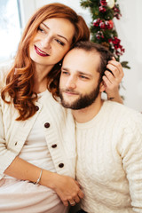 Portrait of dreamy couple hugging before bright window