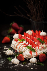 Pavlova meringue cake decorated with fresh strawberry
