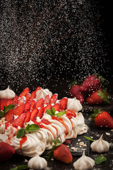 Pavlova meringue cake decorated with fresh strawberry