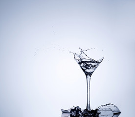 Water splash in a broken goblet. Water drops in a glass. Shattered goblet