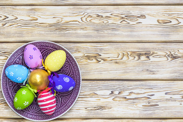 easter, holidays, tradition, advertisement and object concept - close up of colored easter eggs on plate