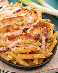 Baked pasta with mushroom sauce and bacon