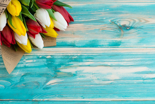 tulips on wooden background with space for text