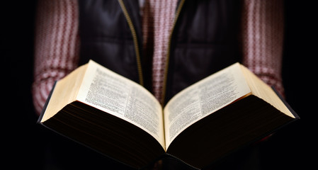 woman holding a book and reading