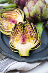 Obraz premium Fresh big Romanesco artichokes green-purple flower heads ready to cook