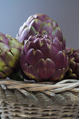 Obraz premium Fresh big Romanesco artichokes green-purple flower heads ready to cook
