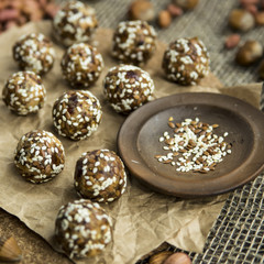 Fototapeta na wymiar Raw dumplings of dates and nut flour in the crooked and flaxseed