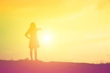 Fototapeta na wymiar Silhouette of woman praying over beautiful sky background