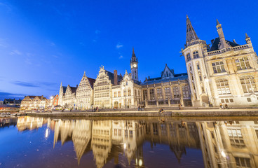 Fototapeta na wymiar GENT, BELGIUM - MARCH 2015: Tourists visit ancient medieval city at night. Gent attracts more than 1 million people annually