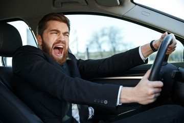 Screaming businessman nearly crashing car during his trip