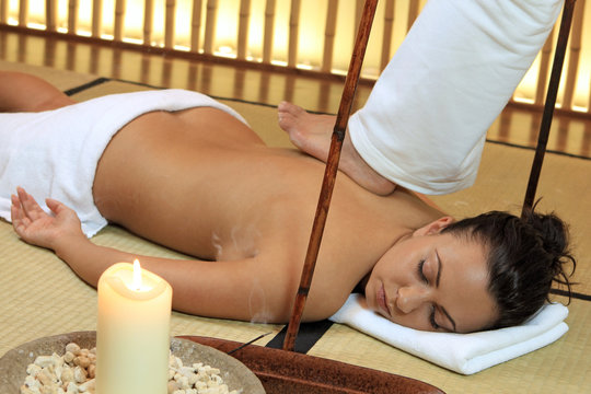 Young woman relaxing with a thai massage