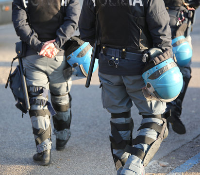Italian police in riot gear with flak jackets and protective hel