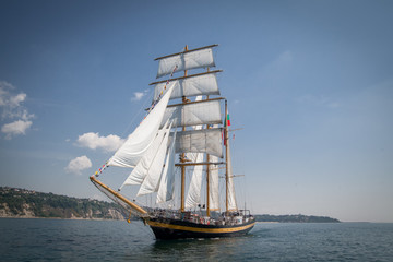 Fototapeta na wymiar Old ship with white sales, sailing in the sea