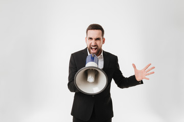 Fototapeta premium Screaming businessman talking with loudspeaker.