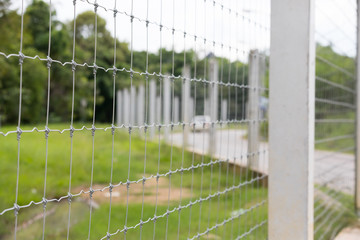 Modern fence made of wire on concrete poles