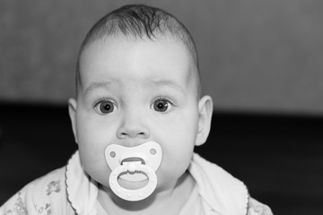 Portrait of a cute baby with a pacifier