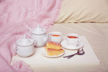 Lemon pie with tea in a white bowl. Breakfast in bed
