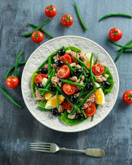 Fresh Tuna Green Bean salad with eggs, tomatoes, beans, olives on white plate. concept healthy food