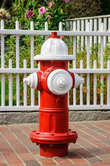 Fototapeta na wymiar Red white fire hydrant on the street