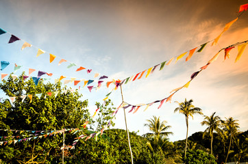Colored flags hanging at tropical beach
