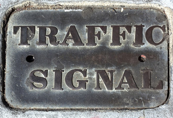 Subsurface TRAFFIC SIGNAL control cover.