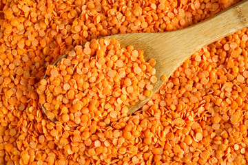 Red Lentils with bamboo cooking spoon background