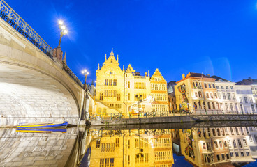 GENT, BELGIUM - MARCH 2015: Tourists visit ancient medieval city at night. Gent attracts more than 1 million people annually
