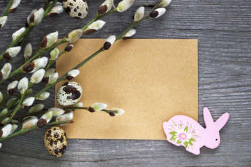 Easter eggs and willow branches on wooden desk. Easter background.