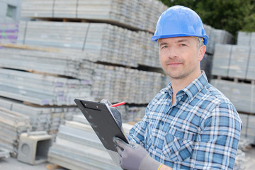 man writing an inventory report