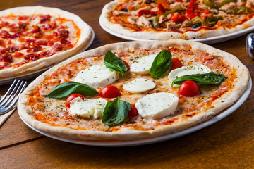 Authentic Italian pizza with mozzarella cheese, basil and cherry tomatoes.