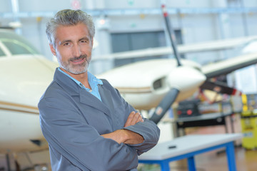 Portrait of man in aircraft hangar