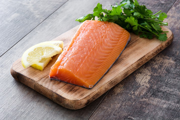 Raw salmon fillet on wooden background

