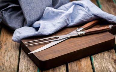 Set of kitchen knifes on a wooden board, top view. Table knives. Cutlery