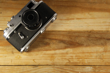 Retro photo camera on wooden background