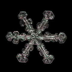 Extreme magnification - Real snowflake on black background, close up